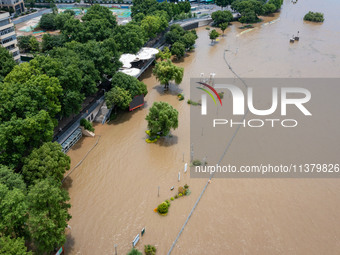 A pedestrian walkway and a platform are flooding in the Nanjing section of the Yangtze River in Nanjing, Jiangsu province, China, on July 3,...