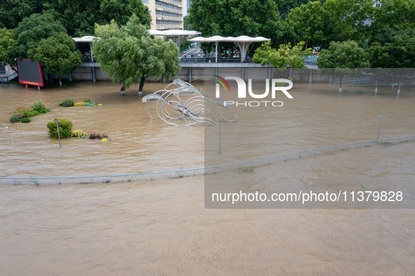 A pedestrian walkway and a platform are flooding in the Nanjing section of the Yangtze River in Nanjing, Jiangsu province, China, on July 3,...