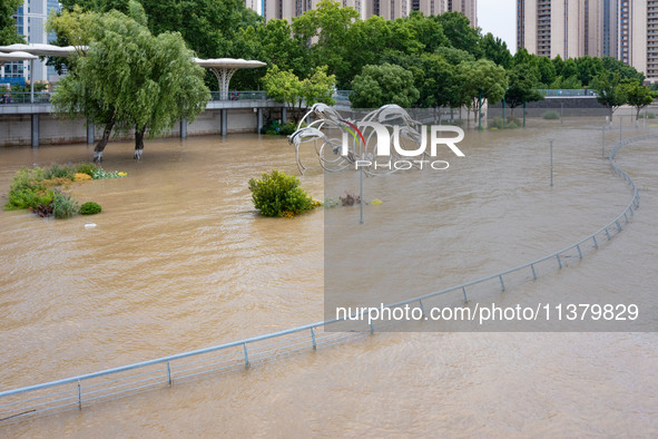 A pedestrian walkway and a platform are flooding in the Nanjing section of the Yangtze River in Nanjing, Jiangsu province, China, on July 3,...