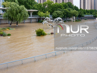 A pedestrian walkway and a platform are flooding in the Nanjing section of the Yangtze River in Nanjing, Jiangsu province, China, on July 3,...