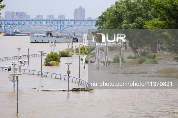 A pedestrian walkway and a platform are flooding in the Nanjing section of the Yangtze River in Nanjing, Jiangsu province, China, on July 3,...