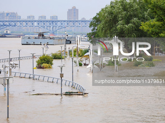 A pedestrian walkway and a platform are flooding in the Nanjing section of the Yangtze River in Nanjing, Jiangsu province, China, on July 3,...