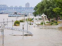 A pedestrian walkway and a platform are flooding in the Nanjing section of the Yangtze River in Nanjing, Jiangsu province, China, on July 3,...