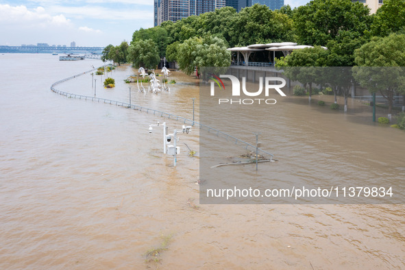 A pedestrian walkway and a platform are flooding in the Nanjing section of the Yangtze River in Nanjing, Jiangsu province, China, on July 3,...