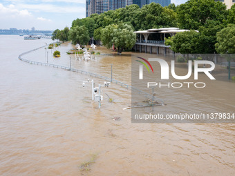 A pedestrian walkway and a platform are flooding in the Nanjing section of the Yangtze River in Nanjing, Jiangsu province, China, on July 3,...