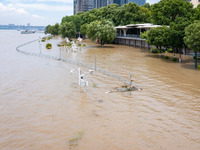 A pedestrian walkway and a platform are flooding in the Nanjing section of the Yangtze River in Nanjing, Jiangsu province, China, on July 3,...