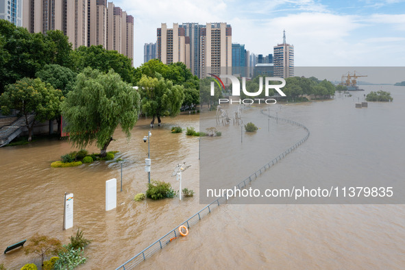 A pedestrian walkway and a platform are flooding in the Nanjing section of the Yangtze River in Nanjing, Jiangsu province, China, on July 3,...