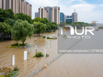 A pedestrian walkway and a platform are flooding in the Nanjing section of the Yangtze River in Nanjing, Jiangsu province, China, on July 3,...