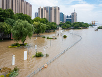 A pedestrian walkway and a platform are flooding in the Nanjing section of the Yangtze River in Nanjing, Jiangsu province, China, on July 3,...