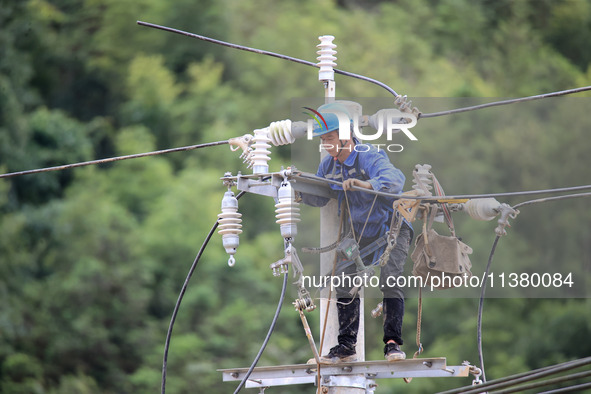 Electric power workers are carrying out repair work after a flood in Si'an village, Rongan County, Liuzhou city, South China's Guangxi Zhuan...