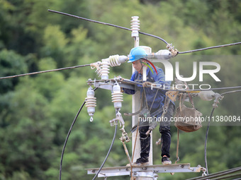 Electric power workers are carrying out repair work after a flood in Si'an village, Rongan County, Liuzhou city, South China's Guangxi Zhuan...