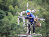 Electric power workers are carrying out repair work after a flood in Si'an village, Rongan County, Liuzhou city, South China's Guangxi Zhuan...