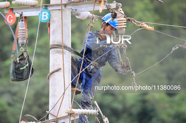 Electric power workers are carrying out repair work after a flood in Si'an village, Rongan County, Liuzhou city, South China's Guangxi Zhuan...