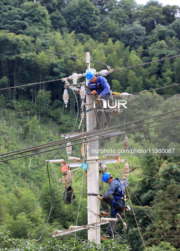 Electric power workers are carrying out repair work after a flood in Si'an village, Rongan County, Liuzhou city, South China's Guangxi Zhuan...