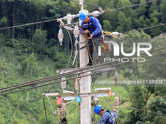 Electric power workers are carrying out repair work after a flood in Si'an village, Rongan County, Liuzhou city, South China's Guangxi Zhuan...