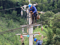 Electric power workers are carrying out repair work after a flood in Si'an village, Rongan County, Liuzhou city, South China's Guangxi Zhuan...