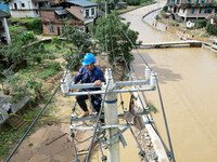 Electric power workers are repairing a power supply line at a pole in Si'an village, Rongan county, Liuzhou city, South China's Guangxi Zhua...