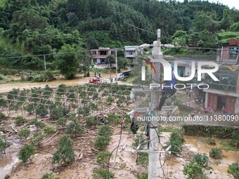 Electric power workers are repairing a power supply line at a pole in Si'an village, Rongan county, Liuzhou city, South China's Guangxi Zhua...