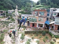 Electric power workers are repairing a power supply line at a pole in Si'an village, Rongan county, Liuzhou city, South China's Guangxi Zhua...