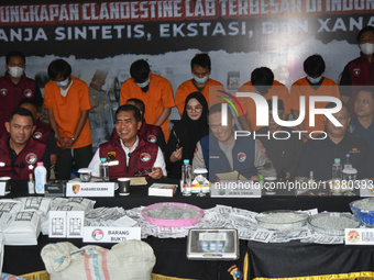 Five suspects (orange shirts) are comprising the makers and dealers in a Chinese clandestine laboratory network that is producing Gloria tob...