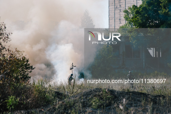 Firefighters are putting out a fire in a field , in Kharkiv, Ukraine, on July 3, 2024. On the afternoon of July 3, 2024, Russia launched an...