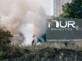 Firefighters are putting out a fire in a field , in Kharkiv, Ukraine, on July 3, 2024. On the afternoon of July 3, 2024, Russia launched an...