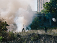 Firefighters are putting out a fire in a field , in Kharkiv, Ukraine, on July 3, 2024. On the afternoon of July 3, 2024, Russia launched an...