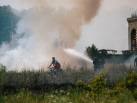 Firefighters are putting out a fire in a field, in Kharkiv, Ukraine, on July 3, 2024. On the afternoon of July 3, 2024, Russia launched an a...