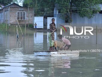 A boy is using a raft in the flood-affected Mayong village in Morigaon district, Assam, India, on July 3, 2024. (