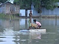 A boy is using a raft in the flood-affected Mayong village in Morigaon district, Assam, India, on July 3, 2024. (