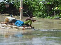 A boy is using a raft in the flood-affected Mayong village in Morigaon district, Assam, India, on July 3, 2024. (