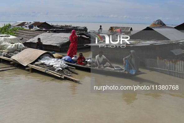 A woman is riding a banana raft in the flood-affected Mayong village in Morigaon district in Assam, India, on July 3, 2024. 