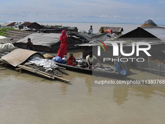 A woman is riding a banana raft in the flood-affected Mayong village in Morigaon district in Assam, India, on July 3, 2024. (