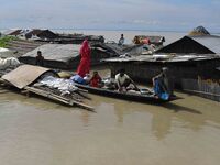 A woman is riding a banana raft in the flood-affected Mayong village in Morigaon district in Assam, India, on July 3, 2024. (