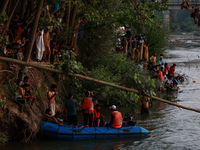 Villagers are watching as SDRF is launching an operation to trace the body of a young man who drowned in Nalla Puhroo while taking a bath on...