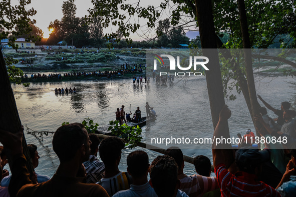 Villagers are watching as SDRF is launching an operation to trace the body of a young man who drowned in Nalla Puhroo while taking a bath on...