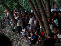 Villagers are watching as SDRF is launching an operation to trace the body of a young man who drowned in Nalla Puhroo while taking a bath on...