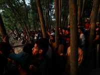 Villagers are watching as SDRF is launching an operation to trace the body of a young man who drowned in Nalla Puhroo while taking a bath on...