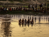 Villagers are watching as SDRF is launching an operation to trace the body of a young man who drowned in Nalla Puhroo while taking a bath on...