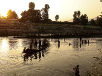 Villagers are watching as SDRF is launching an operation to trace the body of a young man who drowned in Nalla Puhroo while taking a bath on...