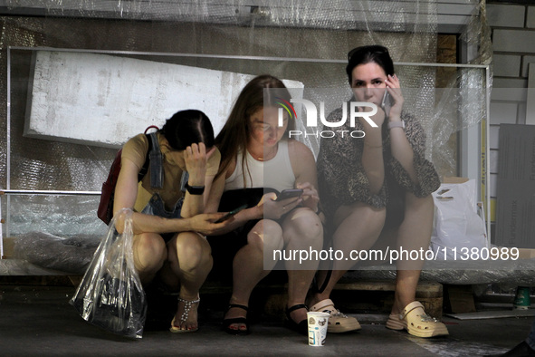 Women are sitting on the ground after the Russian missile strike in Dnipro, Ukraine, on July 3, 2024. At least five people are being reporte...