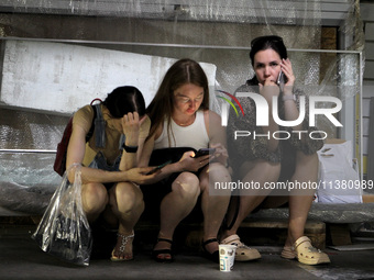 Women are sitting on the ground after the Russian missile strike in Dnipro, Ukraine, on July 3, 2024. At least five people are being reporte...