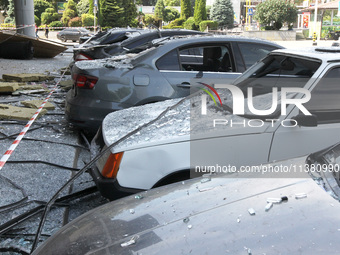 Damaged cars are being pictured outside a shopping mall affected by the Russian missile strike in Dnipro, Ukraine, on July 3, 2024. At least...