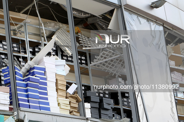 Shoe boxes are being stacked at a smashed window in a shopping mall damaged by the Russian missile strike in Dnipro, Ukraine, on July 3, 202...