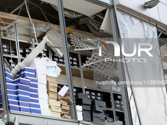 Shoe boxes are being stacked at a smashed window in a shopping mall damaged by the Russian missile strike in Dnipro, Ukraine, on July 3, 202...