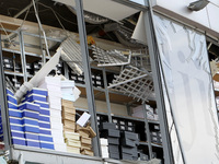 Shoe boxes are being stacked at a smashed window in a shopping mall damaged by the Russian missile strike in Dnipro, Ukraine, on July 3, 202...