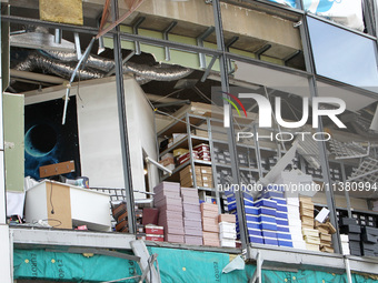 Shoe boxes are being stacked at a smashed window in a shopping mall damaged by the Russian missile strike in Dnipro, Ukraine, on July 3, 202...