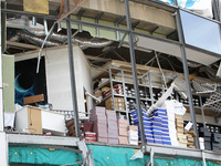 Shoe boxes are being stacked at a smashed window in a shopping mall damaged by the Russian missile strike in Dnipro, Ukraine, on July 3, 202...