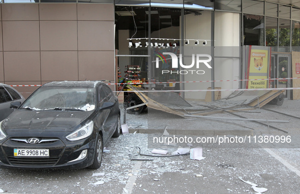 A damaged car is being pictured outside a shopping mall affected by the Russian missile strike in Dnipro, Ukraine, on July 3, 2024. At least...