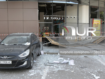 A damaged car is being pictured outside a shopping mall affected by the Russian missile strike in Dnipro, Ukraine, on July 3, 2024. At least...